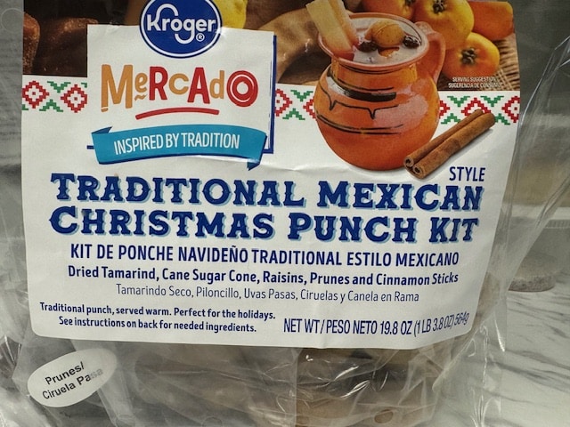A bag of Kroger Mercado brand Traditional Mexican Christmas Punch Kit, featuring dried fruits and cinnamon sticks.